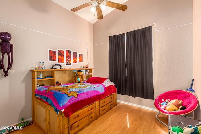 bedroom featuring lofted ceiling, wood-type flooring, and ceiling fan