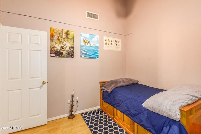 bedroom with hardwood / wood-style flooring