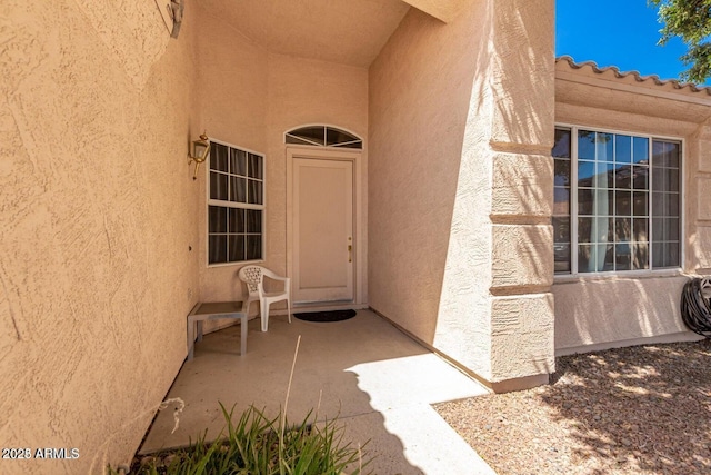 property entrance featuring a patio