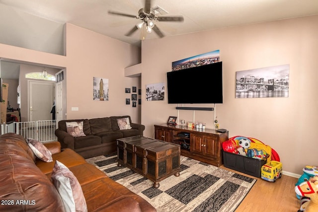 living room featuring lofted ceiling, hardwood / wood-style floors, and ceiling fan