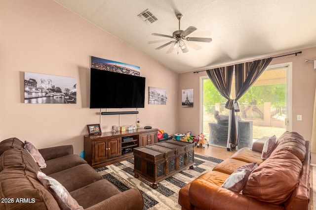 living room with ceiling fan, lofted ceiling, and wood-type flooring