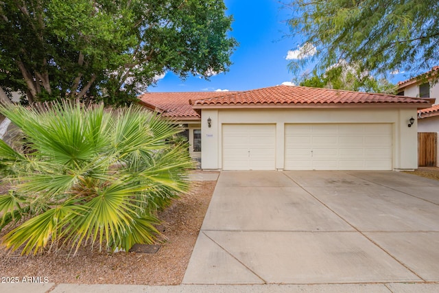 5428 W Wethersfield Dr, Glendale, AZ 85304 - view of front facade featuring driveway, a tile roof, a garage, and stucco siding