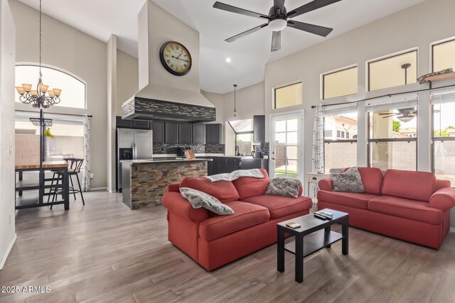 5428 W Wethersfield Dr, Glendale, AZ 85304 - living area featuring a high ceiling, ceiling fan with notable chandelier, and light wood finished floors