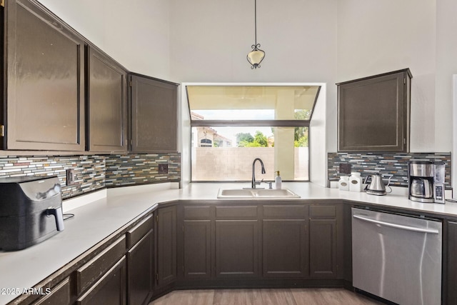 5428 W Wethersfield Dr, Glendale, AZ 85304 - kitchen featuring backsplash, light countertops, a sink, and stainless steel dishwasher