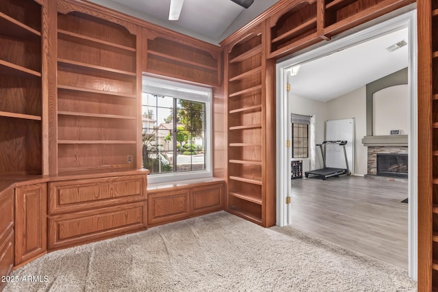 5428 W Wethersfield Dr, Glendale, AZ 85304 - unfurnished office with a stone fireplace, vaulted ceiling, and visible vents
