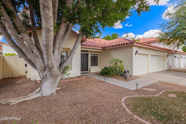 5428 W Wethersfield Dr, Glendale, AZ 85304 - view of front of home featuring concrete driveway, stucco siding, fence, a tiled roof, and a garage