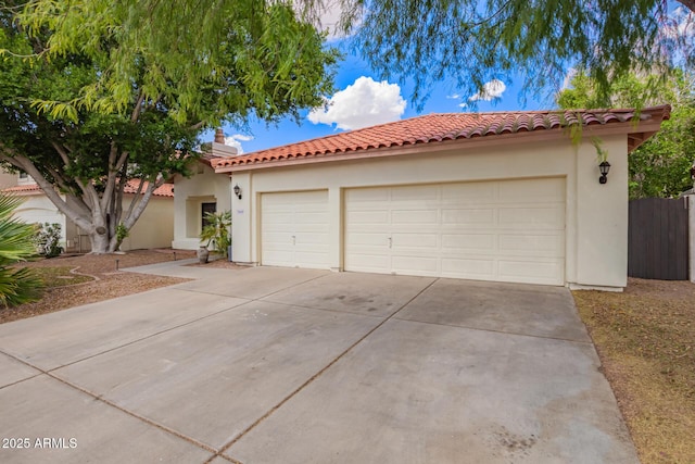 5428 W Wethersfield Dr, Glendale, AZ 85304 - view of front facade featuring concrete driveway, stucco siding, fence, a tiled roof, and a garage