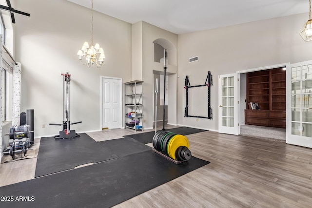 5428 W Wethersfield Dr, Glendale, AZ 85304 - workout area featuring baseboards, visible vents, high vaulted ceiling, and wood finished floors