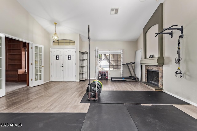 5428 W Wethersfield Dr, Glendale, AZ 85304 - exercise area featuring visible vents, baseboards, a fireplace with raised hearth, wood finished floors, and french doors