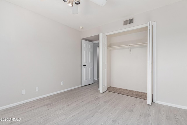 unfurnished bedroom featuring a closet, ceiling fan, and light wood-type flooring