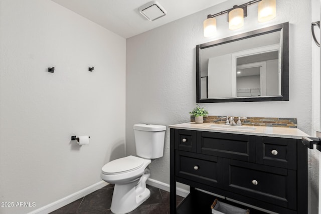 bathroom featuring tile patterned flooring, vanity, and toilet