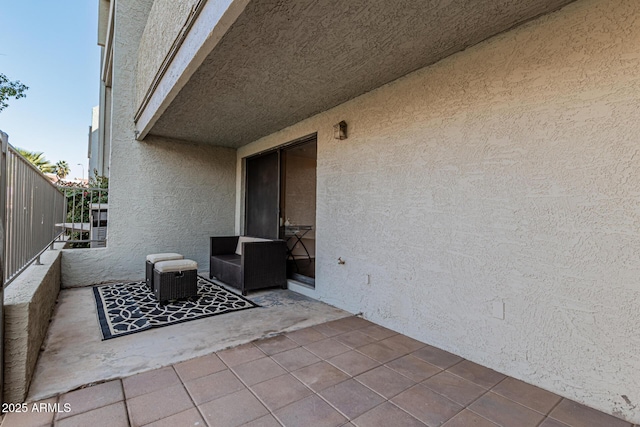 view of patio featuring central AC and a balcony