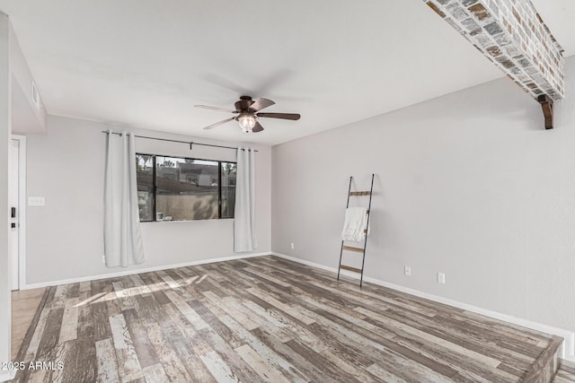 unfurnished living room with hardwood / wood-style flooring and ceiling fan