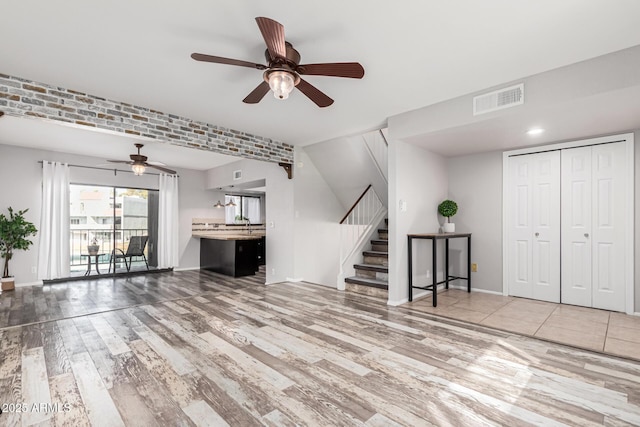 unfurnished living room featuring hardwood / wood-style floors and ceiling fan