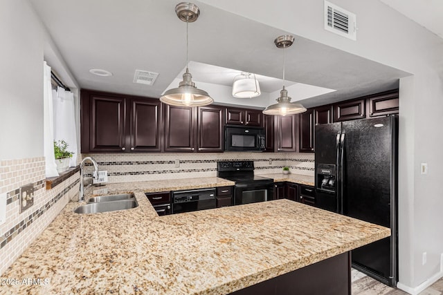 kitchen featuring pendant lighting, black appliances, sink, dark brown cabinetry, and kitchen peninsula