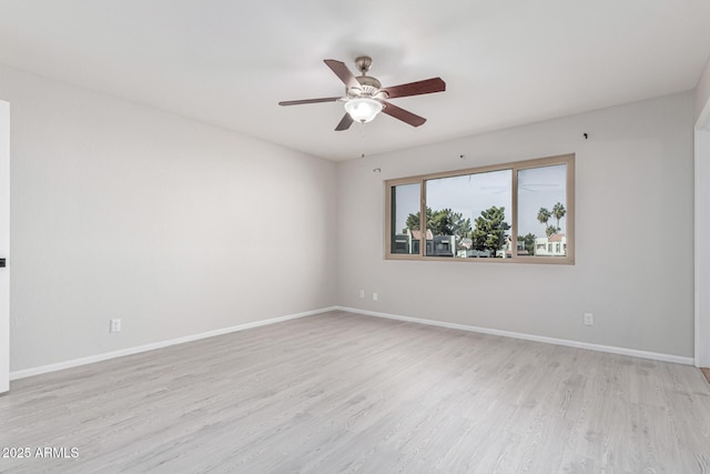 empty room with ceiling fan and light hardwood / wood-style flooring