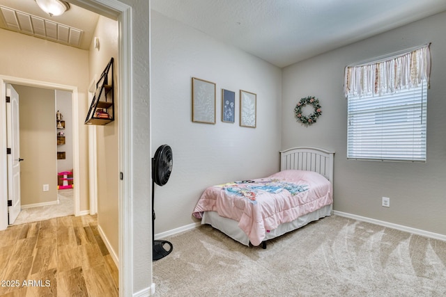 bedroom featuring light carpet