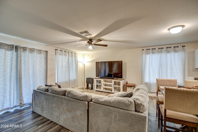 living room featuring hardwood / wood-style flooring and ceiling fan