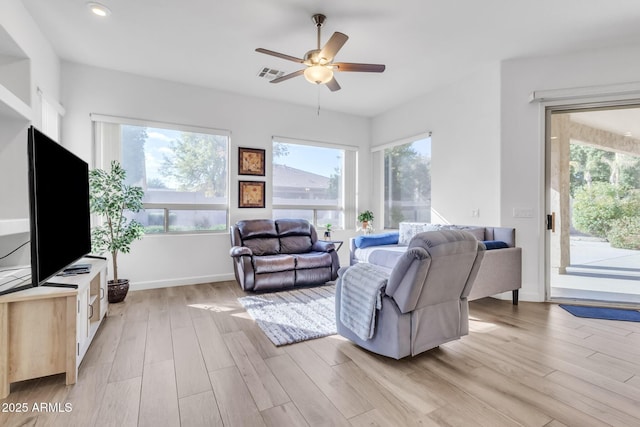 living room with ceiling fan and light hardwood / wood-style flooring