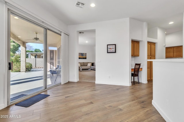 interior space with ceiling fan and light hardwood / wood-style floors