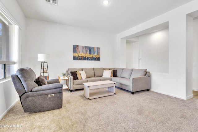 living room with light colored carpet and a healthy amount of sunlight