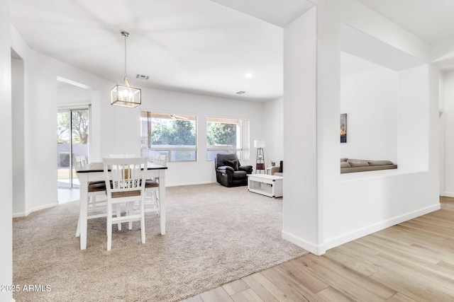 dining room featuring a notable chandelier and light hardwood / wood-style flooring