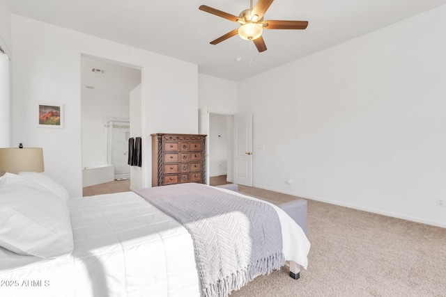 carpeted bedroom with ensuite bath and ceiling fan