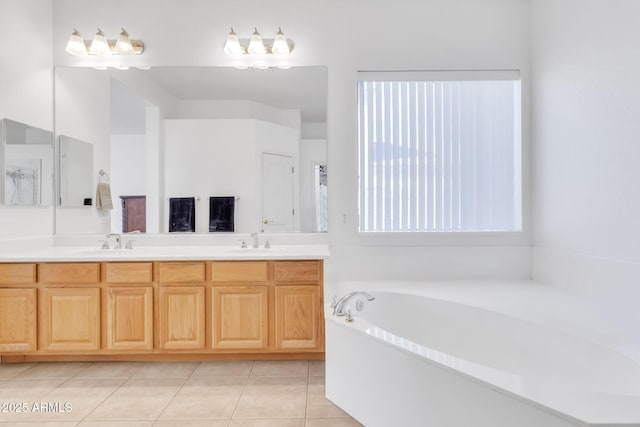 bathroom featuring tile patterned floors, vanity, and a washtub