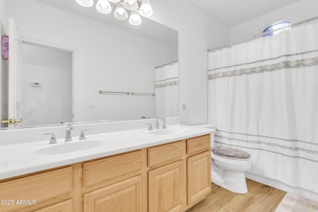 bathroom with vanity, toilet, curtained shower, and hardwood / wood-style floors