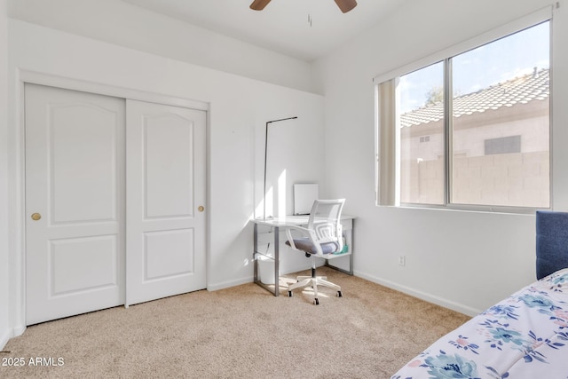 carpeted bedroom featuring ceiling fan and a closet