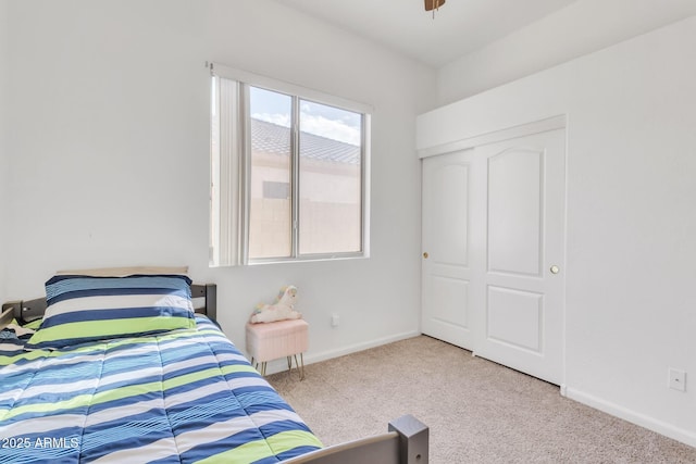 bedroom featuring light colored carpet and a closet