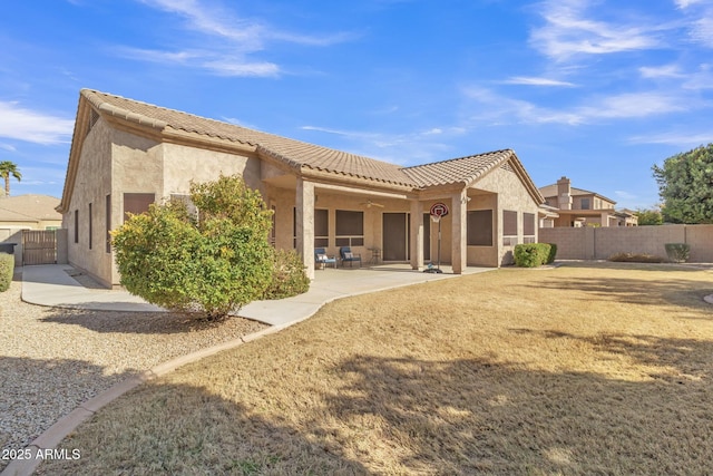 rear view of house with a patio and ceiling fan