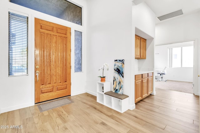 foyer with built in desk and light hardwood / wood-style floors