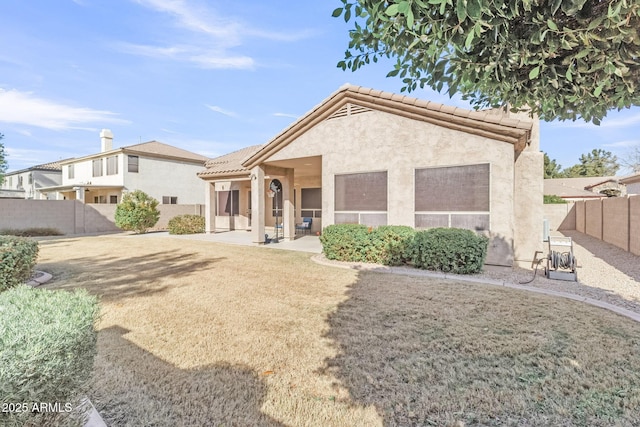 view of front of home featuring a front lawn and a patio