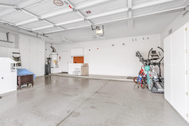 garage featuring a garage door opener and water heater