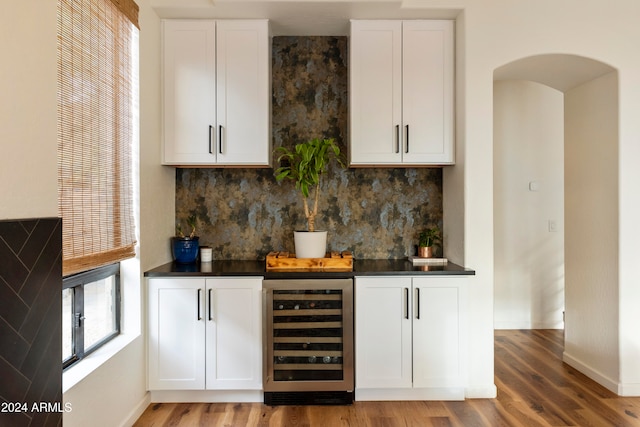 bar featuring white cabinetry, hardwood / wood-style floors, tasteful backsplash, and wine cooler