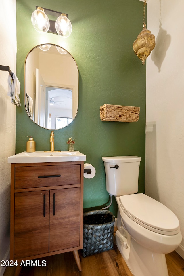 bathroom featuring hardwood / wood-style flooring, vanity, and toilet