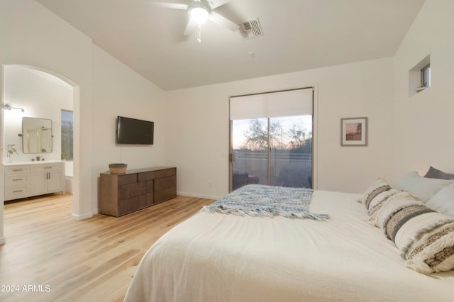 bedroom featuring ensuite bathroom, lofted ceiling, ceiling fan, and light hardwood / wood-style flooring