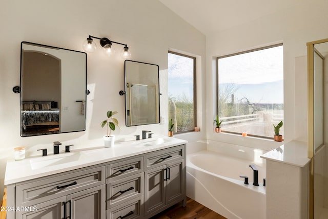 bathroom with shower with separate bathtub, lofted ceiling, hardwood / wood-style flooring, and vanity