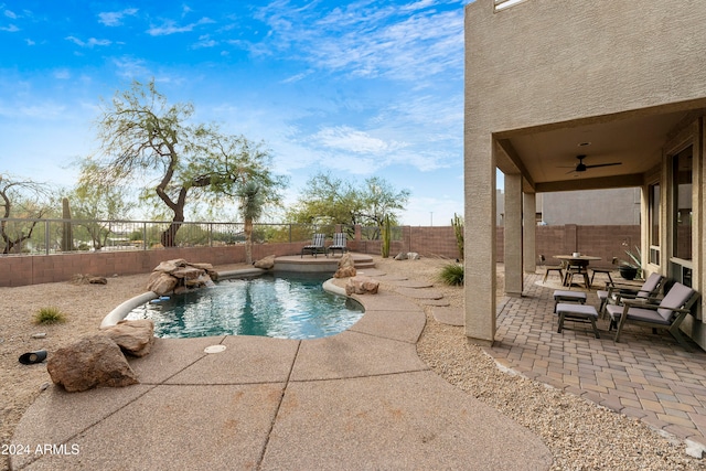 view of swimming pool featuring a patio, ceiling fan, and pool water feature