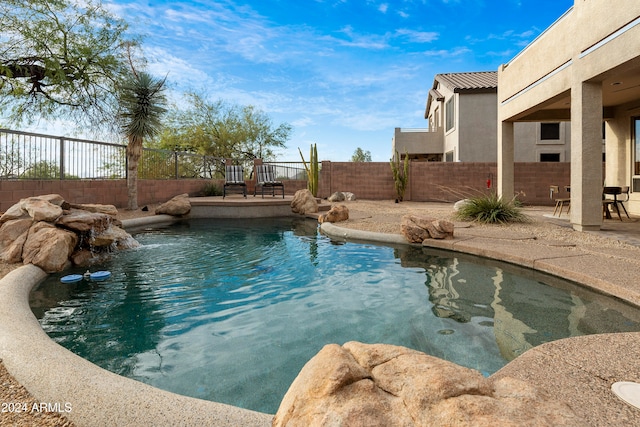 view of pool with pool water feature