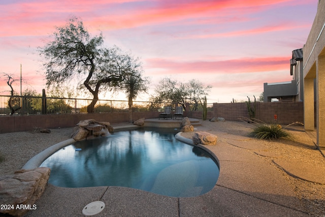 view of pool at dusk