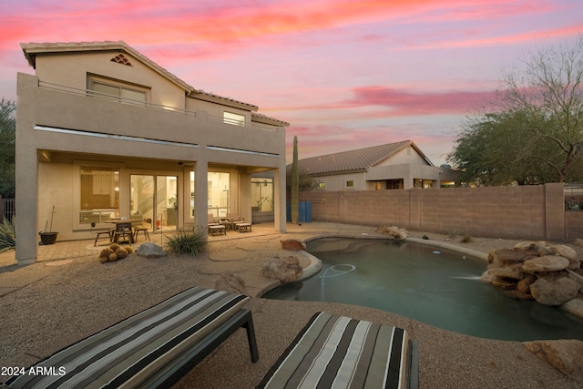 exterior space with a fenced in pool, a patio, and a balcony