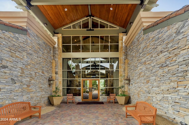 view of exterior entry featuring french doors and a patio