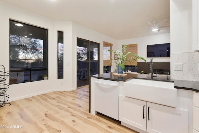 kitchen featuring white cabinetry, sink, dishwasher, light wood-type flooring, and decorative backsplash