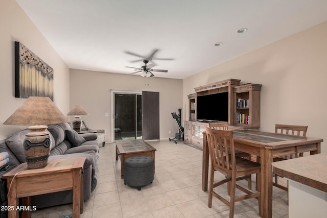 tiled living room with ceiling fan