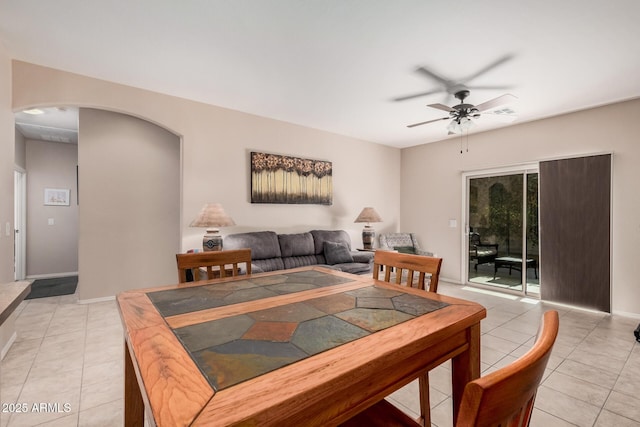 tiled dining room with ceiling fan