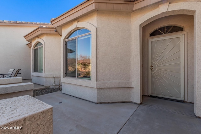 entrance to property with a patio