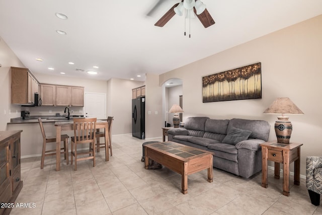 living room with ceiling fan and light tile patterned floors