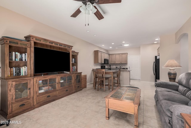 tiled living room with ceiling fan